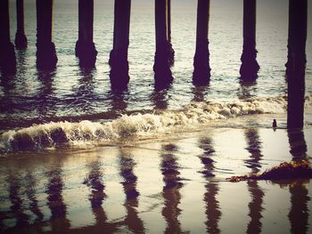 Reflection of pier on sea