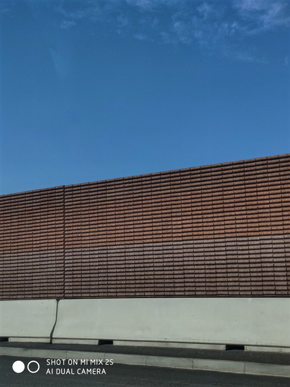 LOW ANGLE VIEW OF TEXT ON BUILDING AGAINST CLEAR SKY