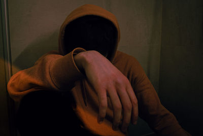 Rear view of man sitting at home