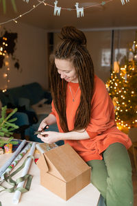 Portrait of young woman holding christmas presents