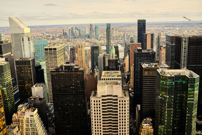 Aerial view of modern buildings in city against sky