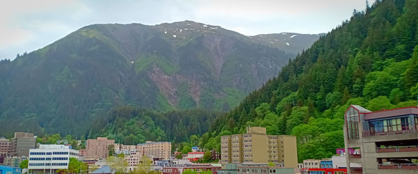 Panoramic view of buildings and mountains against sky