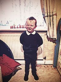 Portrait of smiling man standing against wall