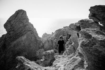 Woman walking on rocky beach