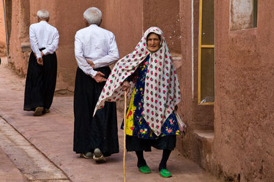 Rear view of people walking outdoors