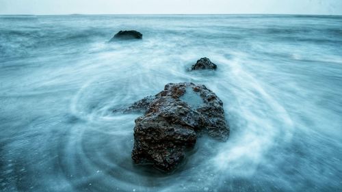 Scenic view of rocks in sea