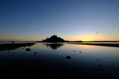 Scenic view of sea against clear sky during sunset