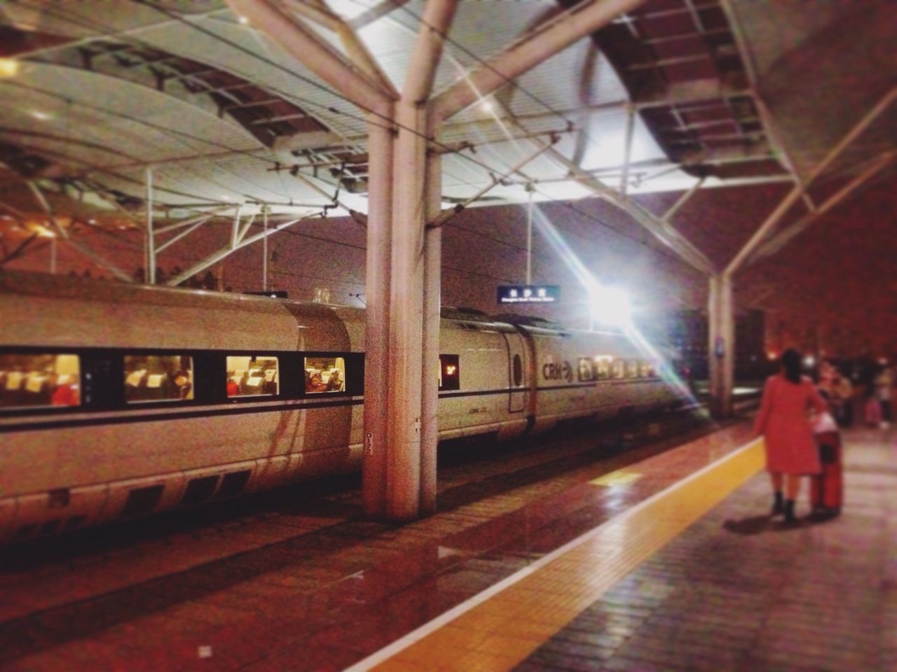 indoors, illuminated, lifestyles, men, architecture, leisure activity, built structure, full length, person, railroad station, standing, railroad station platform, walking, ceiling, rear view, casual clothing, public transportation, lighting equipment