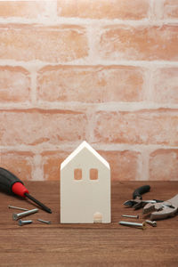 Close-up of stuffed toy against brick wall