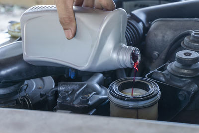 Close up hands of mechanic doing car service and maintenance. hydraulic oil change new replace