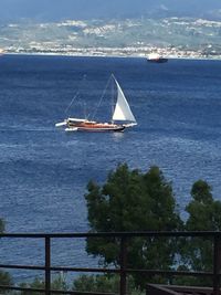 Sailboat sailing on sea against sky