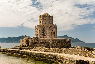 Old ruin building against cloudy sky