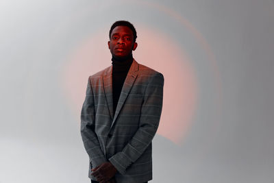 Portrait of businessman standing against white background