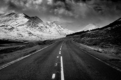Road amidst mountains against sky