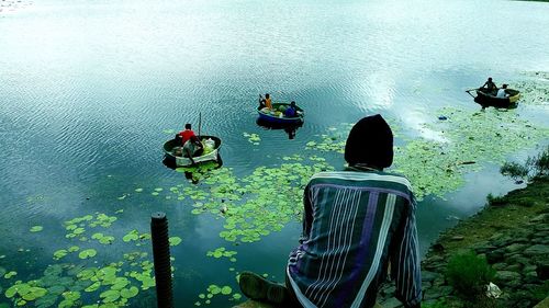 Rear view of man and woman in boat