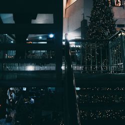 View of illuminated street lights in city at night