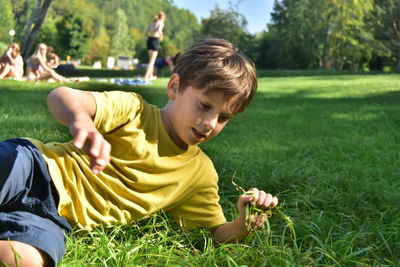 Rear view of boy on field