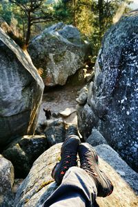 Low section of person standing on rocks