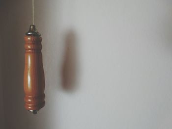 Wooden decoration hanging against wall in room at home