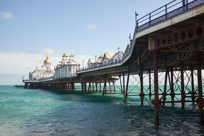 Eastbourne, east sussex, u.k. - low angle view of the pier with blue skies and a sunny day.