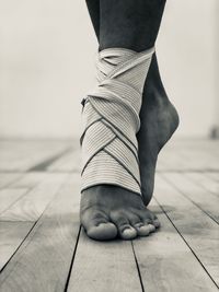 Low section of woman with bandage dancing on hardwood floor