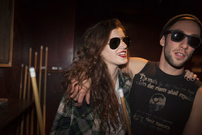 Young couple hanging out at a pool hall