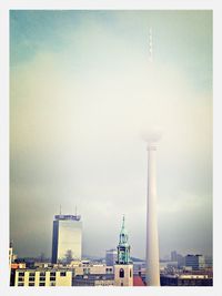 Communications tower against cloudy sky