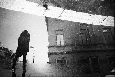 Reflection of building in puddle