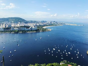 High angle view of buildings by sea against sky