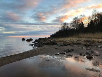 Scenic view of beach against sky during sunset