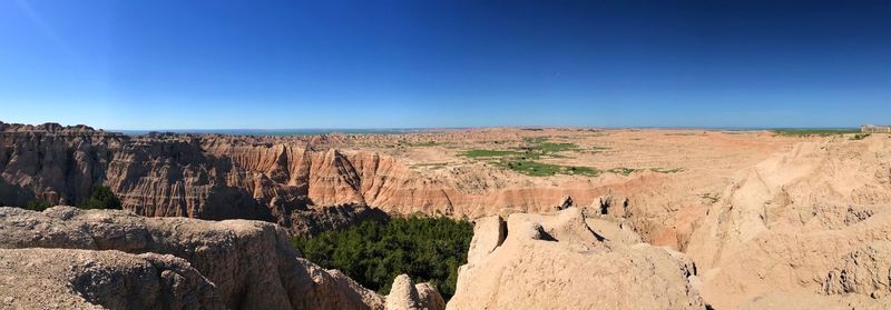 Panoramic view of landscape against blue sky