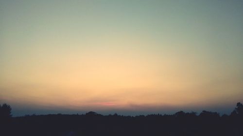 Scenic view of silhouette trees against sky during sunset