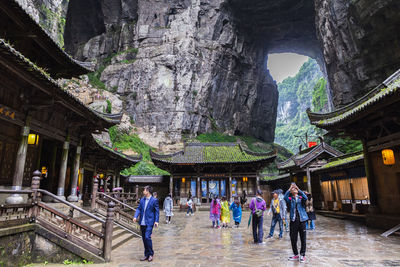 People walking in temple outside building