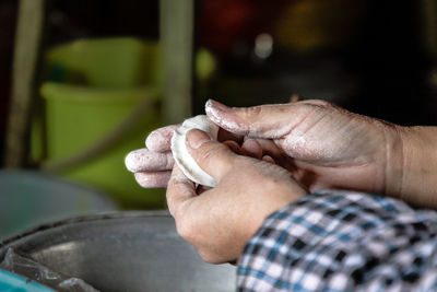 Close-up of man preparing chinese dumpling