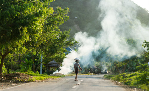 Rear view of a man on road