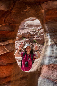 Portrait of woman standing on rock