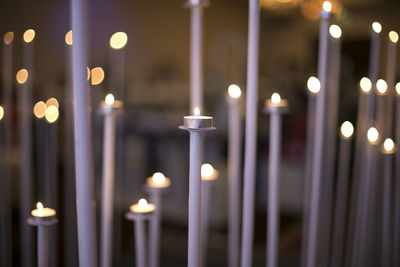Close-up of burning candles in church
