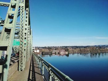 Bridge over river against buildings in city