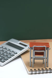 Close-up of miniature classroom equipment over white background