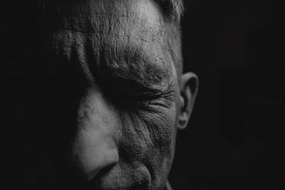 Cropped image of man against black background