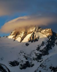 Scenic view of snow covered mountains against sky