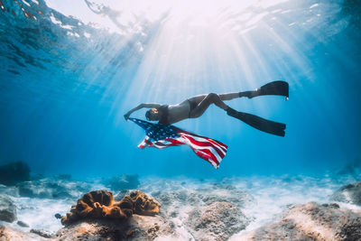 Low angle view of man swimming in sea