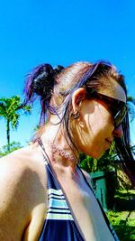 Beautiful young woman against sky