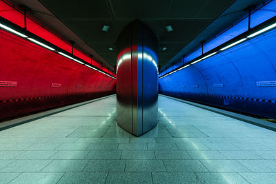 Diminishing perspective of illuminated railroad station platform