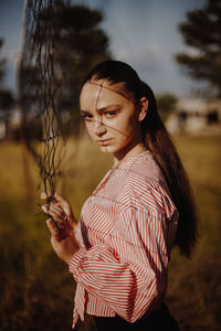 Young woman standing on field