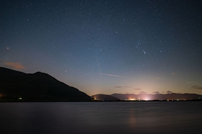 Scenic view of sea against sky at night