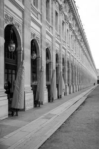 People walking on street amidst buildings in city