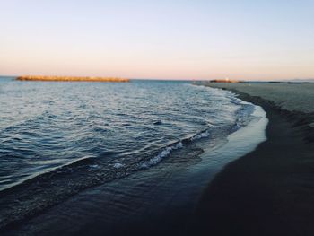 Scenic view of sea against clear sky during sunset
