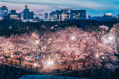 Illuminated cityscape against sky at night