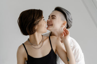 Portrait of smiling woman against white background